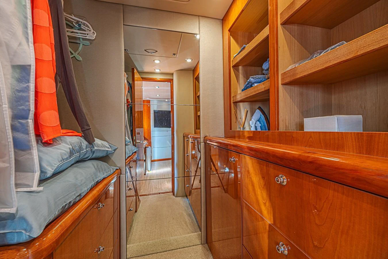 The image showcases a well-organized interior storage area with wooden cabinetry and ample shelving. aboard BIG CHUBBY XL Yacht for Sale
