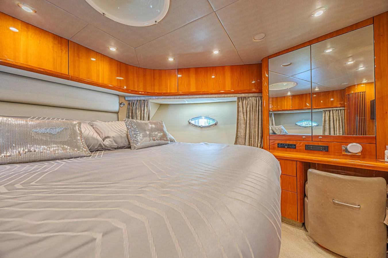 The master stateroom features a spacious bed with elegant bedding and ample lighting. aboard BIG CHUBBY XL Yacht for Sale