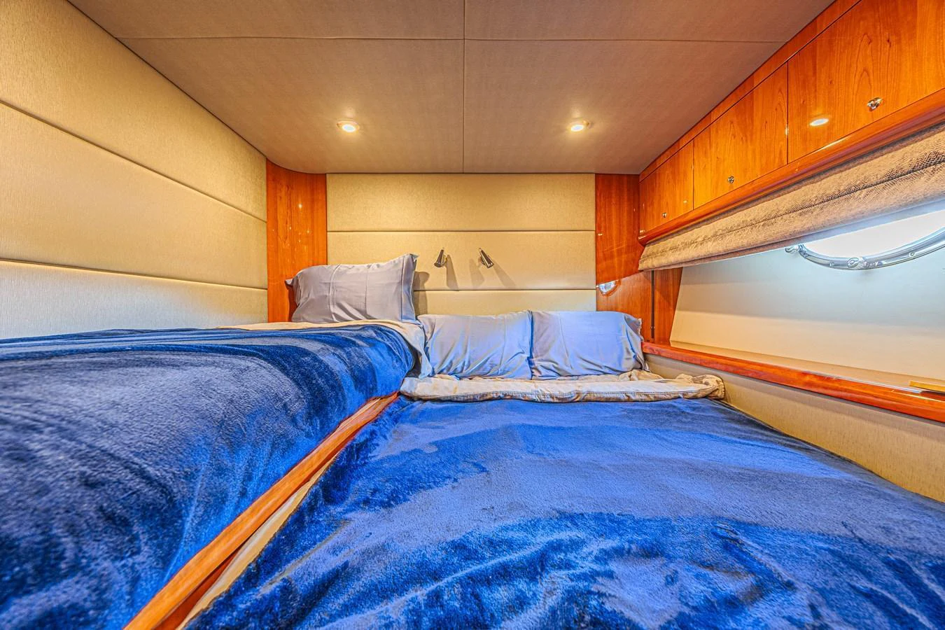 A cozy stateroom with plush bedding and warm lighting. aboard BIG CHUBBY XL Yacht for Sale