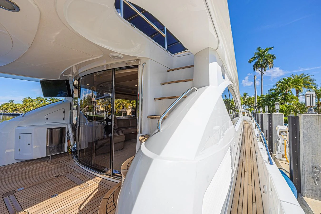 The aft deck features a spacious lounging area with access to the interior through sliding glass doors. aboard BIG CHUBBY XL Yacht for Sale