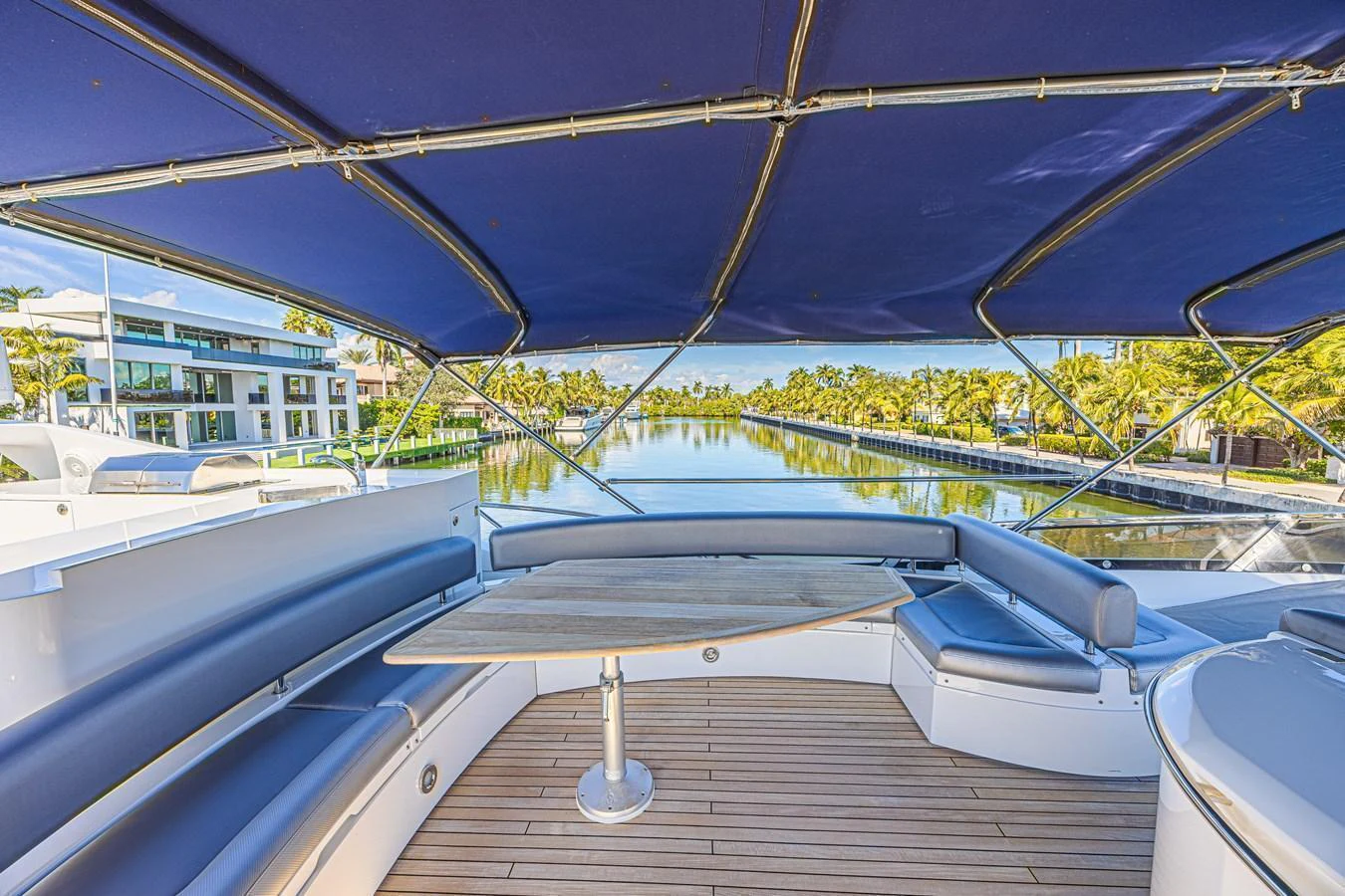 The flybridge offers a spacious seating area with a table, perfect for enjoying scenic views. aboard BIG CHUBBY XL Yacht for Sale