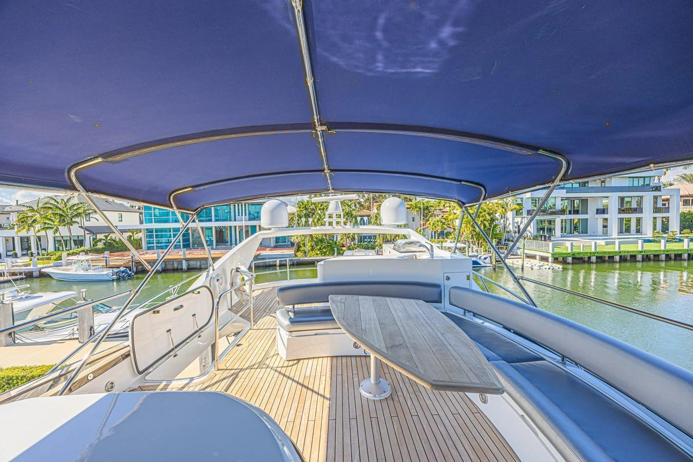The flybridge offers a spacious and shaded area for relaxation and dining with a view of the marina. aboard BIG CHUBBY XL Yacht for Sale