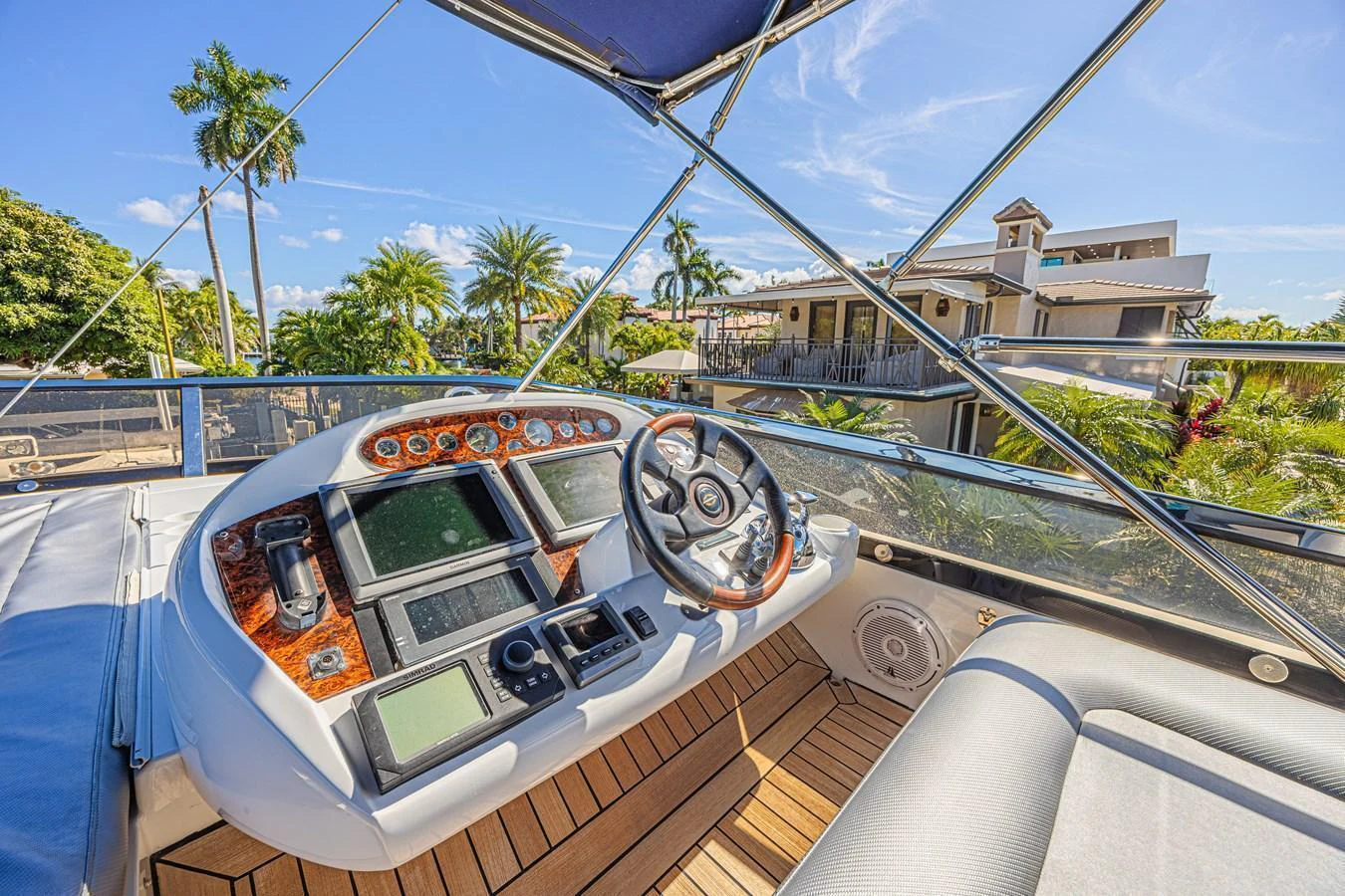 The helm station offers a commanding view with state-of-the-art navigation equipment and luxurious wood accents. aboard BIG CHUBBY XL Yacht for Sale