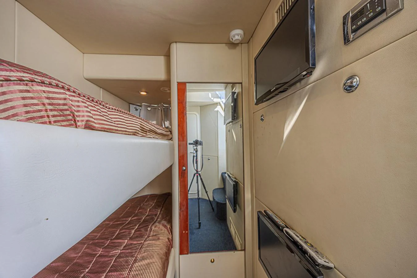 A cozy cabin featuring bunk beds and modern amenities. aboard BIG CHUBBY XL Yacht for Sale