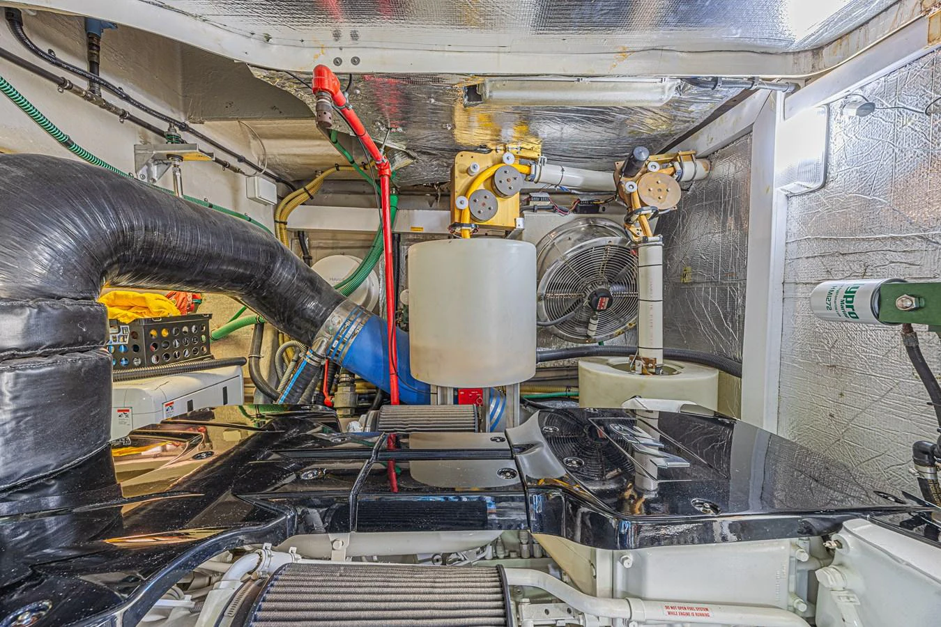 The image showcases the yacht's well-maintained engine room with various mechanical components. aboard BIG CHUBBY XL Yacht for Sale
