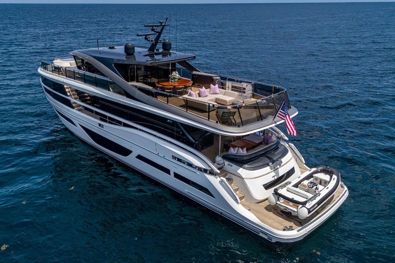 a boat with a flag on it aboard SPLASH Yacht for Sale