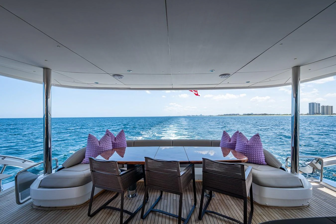 a table and chairs on a deck overlooking a large body of water aboard SPLASH Yacht for Sale