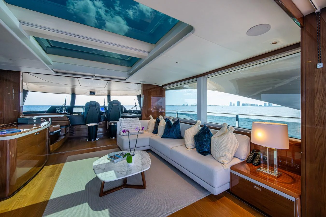 a room with a couch and a table and a window aboard SPLASH Yacht for Sale