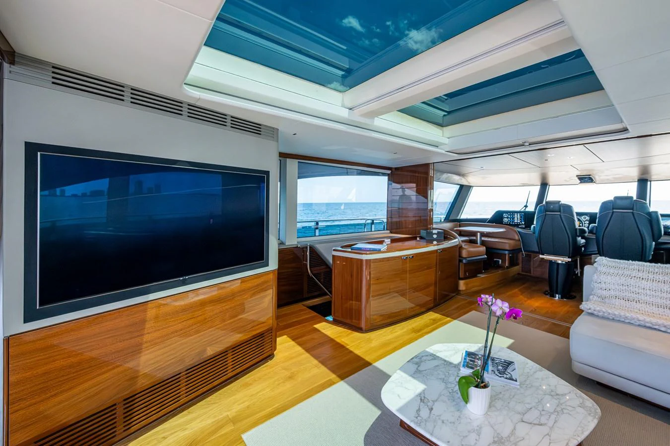 a room with a tv and a table aboard SPLASH Yacht for Sale