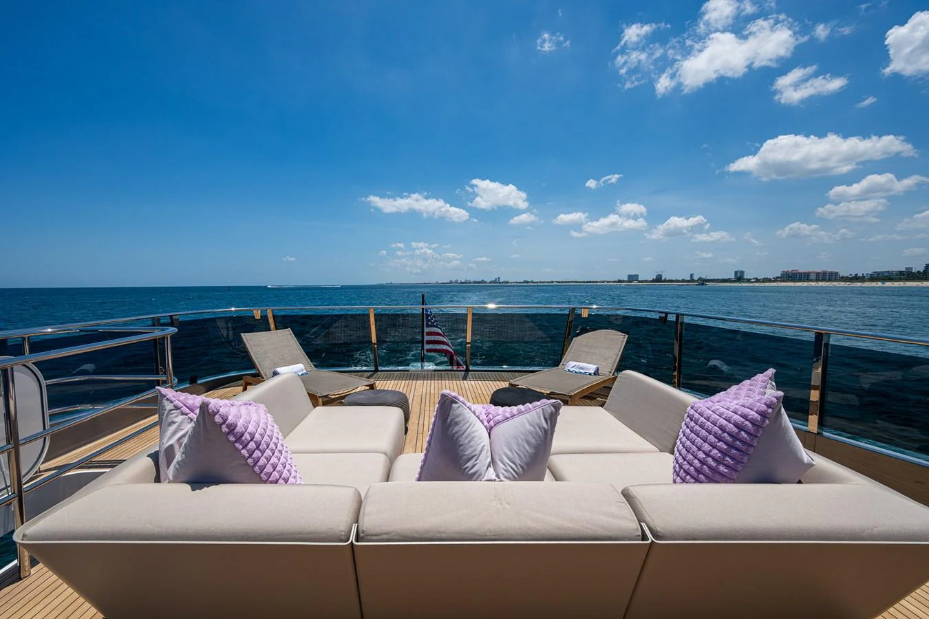 a group of white couches on a boat in the water aboard SPLASH Yacht for Sale