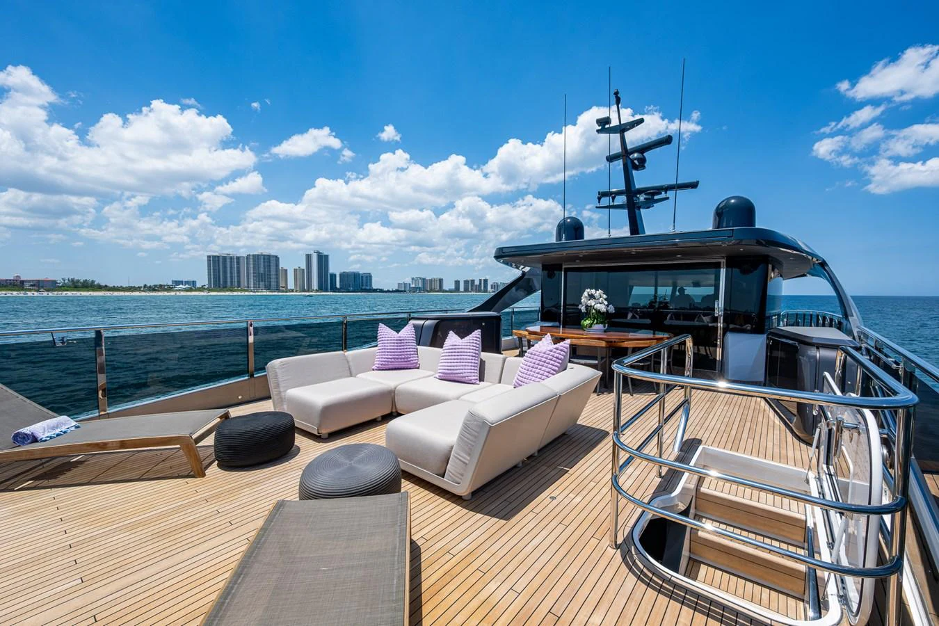 a deck with a large body of water and a large boat on it aboard SPLASH Yacht for Sale