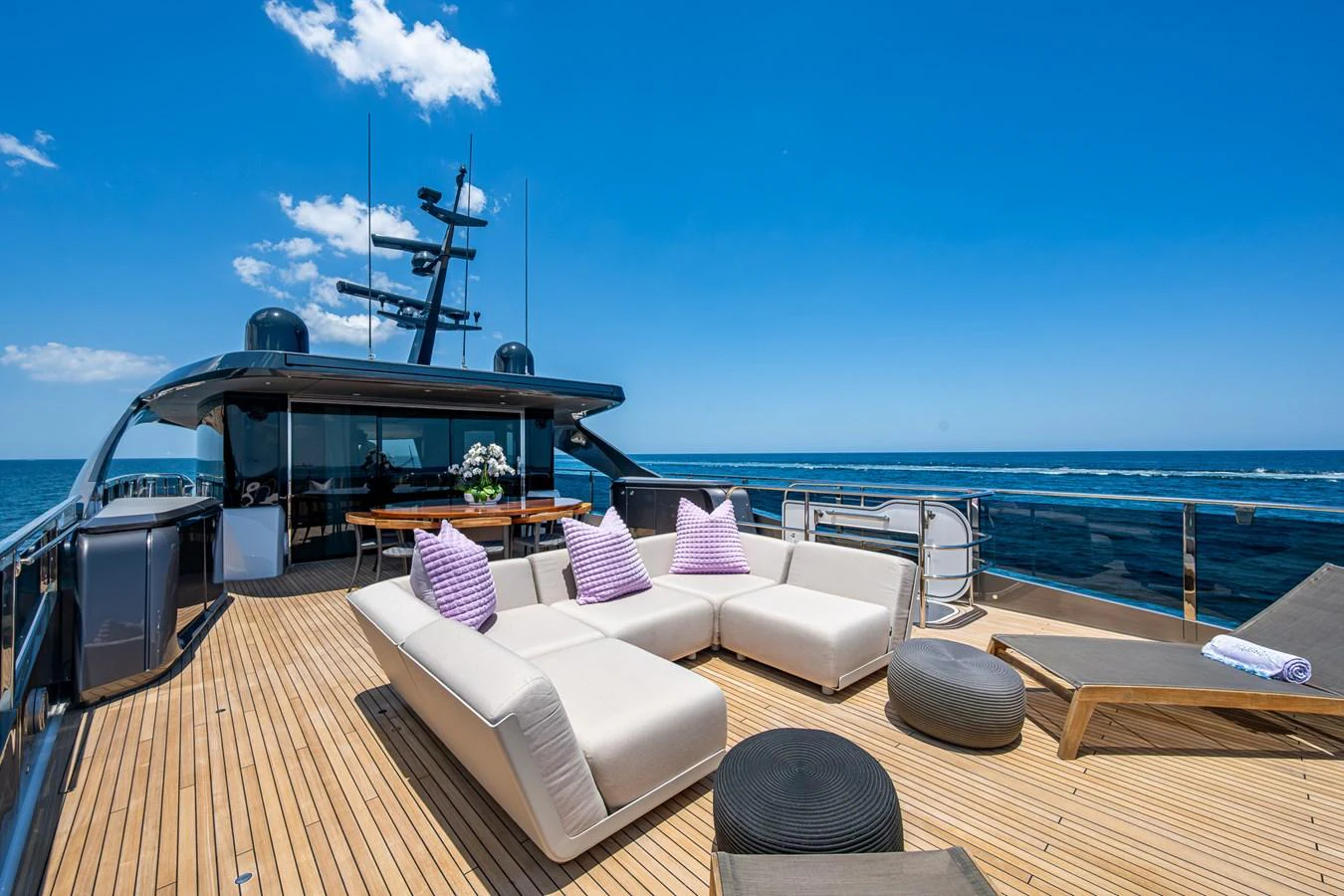 a deck with a large ship in the background aboard SPLASH Yacht for Sale