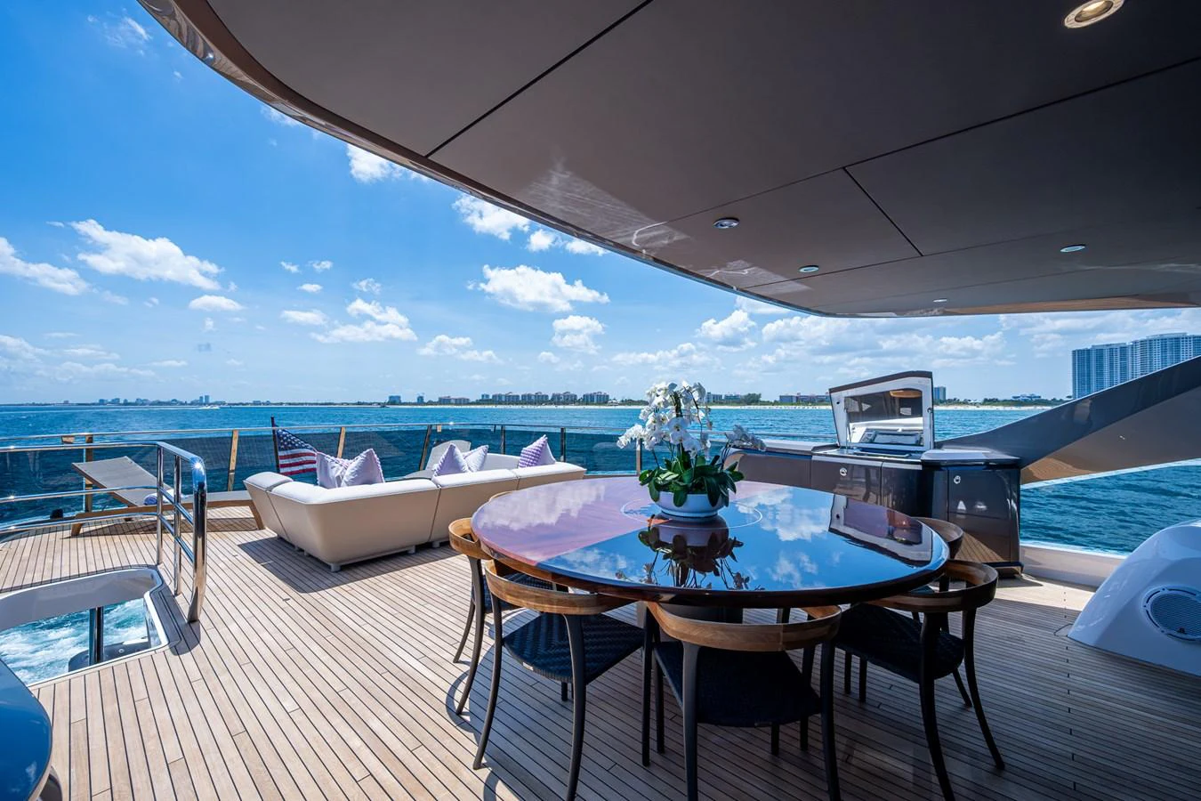 a table and chairs on a deck overlooking a large body of water aboard SPLASH Yacht for Sale