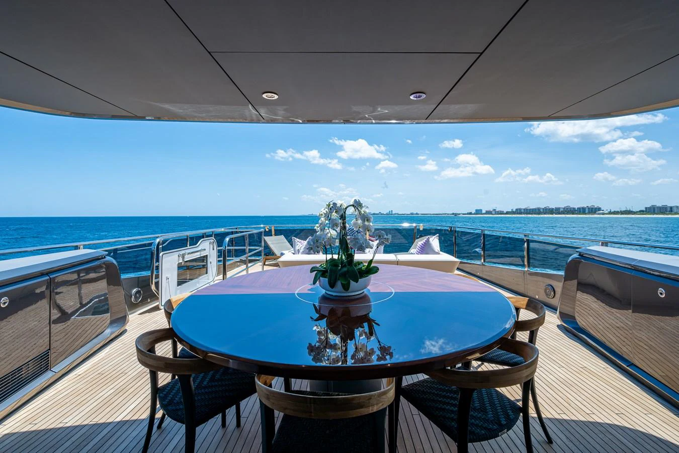 a table on a deck overlooking the ocean aboard SPLASH Yacht for Sale