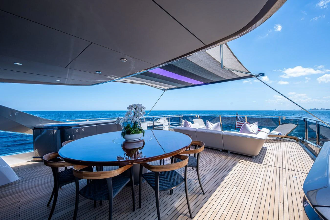 a table on a deck overlooking the ocean aboard SPLASH Yacht for Sale