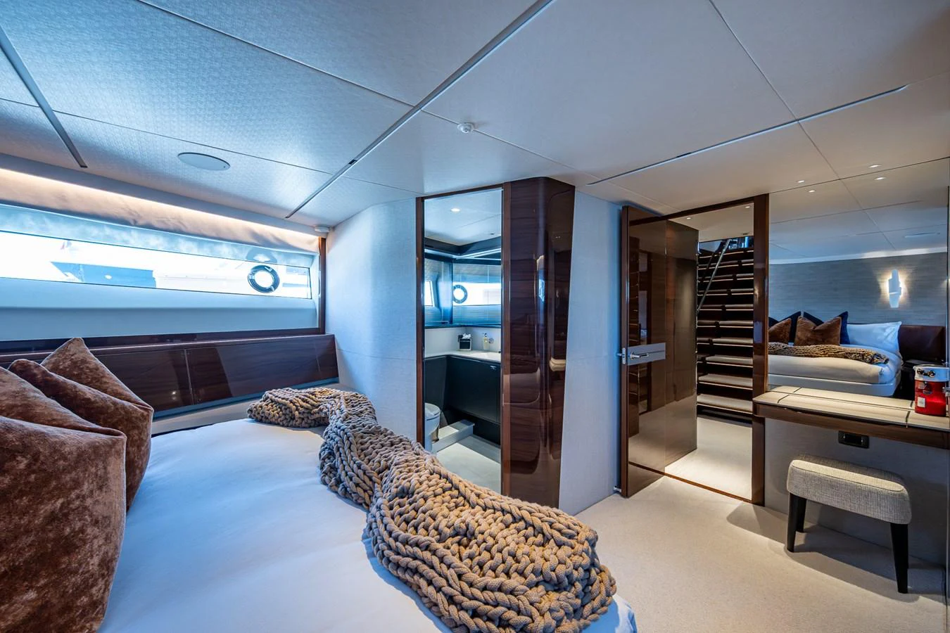 a room with a couch and a staircase aboard SPLASH Yacht for Sale