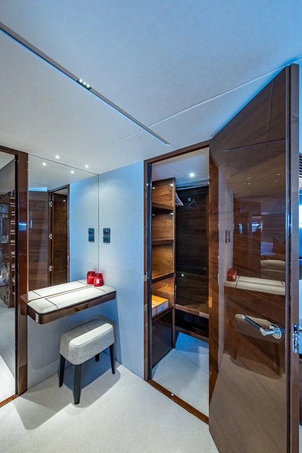 a room with a desk and a closet aboard SPLASH Yacht for Sale