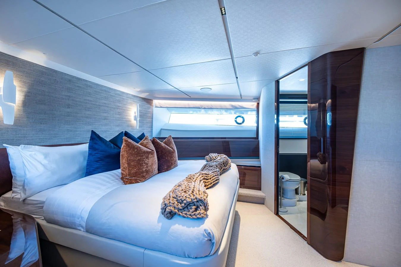 a room with a bed and a window aboard SPLASH Yacht for Sale