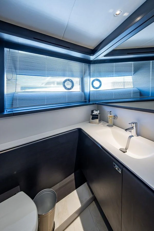a bathroom with a sink and a window aboard SPLASH Yacht for Sale