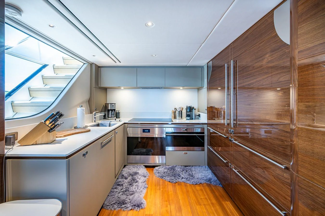 a kitchen with wooden cabinets aboard SPLASH Yacht for Sale