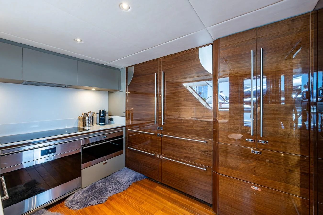a kitchen with wooden cabinets aboard SPLASH Yacht for Sale