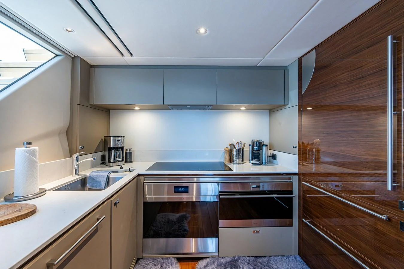 a kitchen with a wooden cabinet aboard SPLASH Yacht for Sale