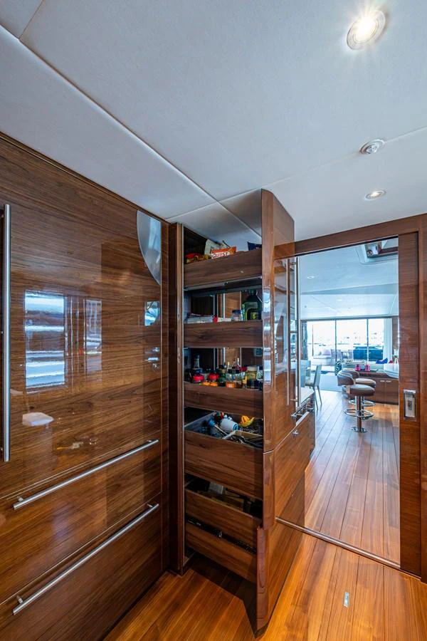 a wooden cabinet in a room aboard SPLASH Yacht for Sale