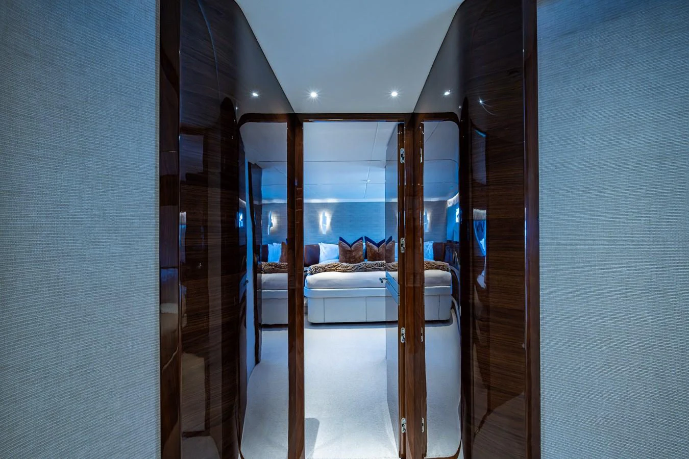a room with a bed and a mirror aboard SPLASH Yacht for Sale