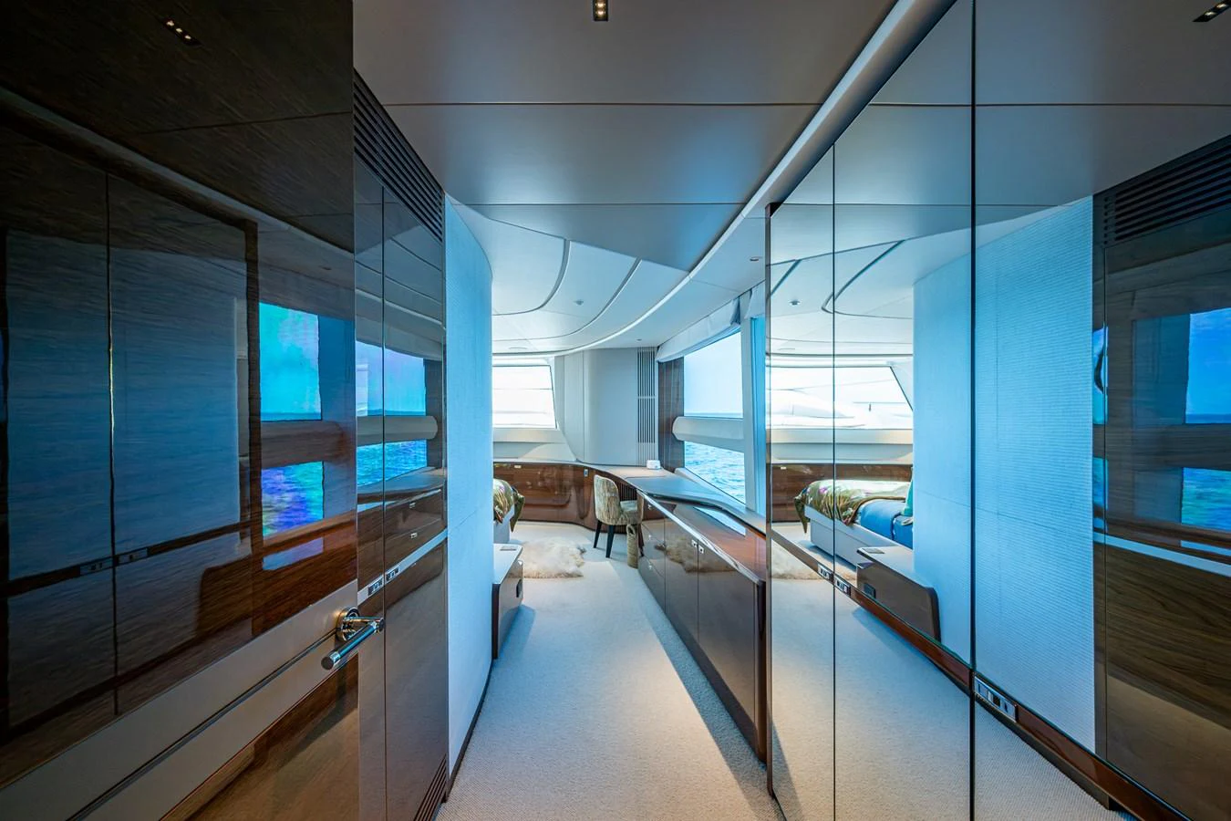 a room with glass walls and a hallway with a window and a couch aboard SPLASH Yacht for Sale