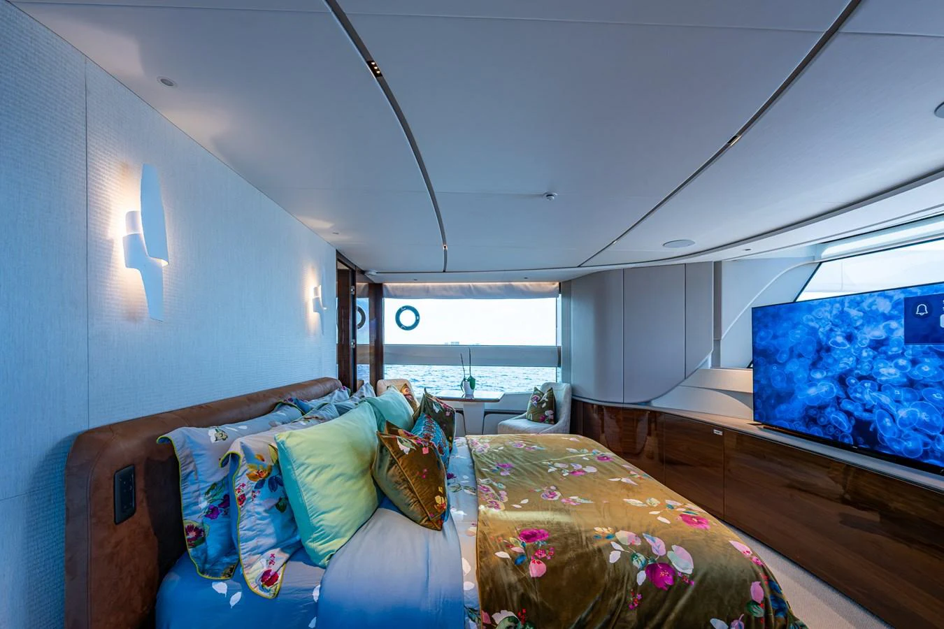a bedroom with a bed and a tv aboard SPLASH Yacht for Sale