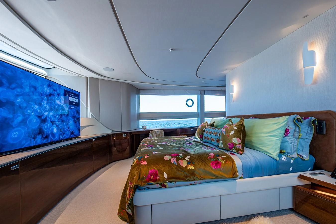 a bedroom with a bed and a window aboard SPLASH Yacht for Sale