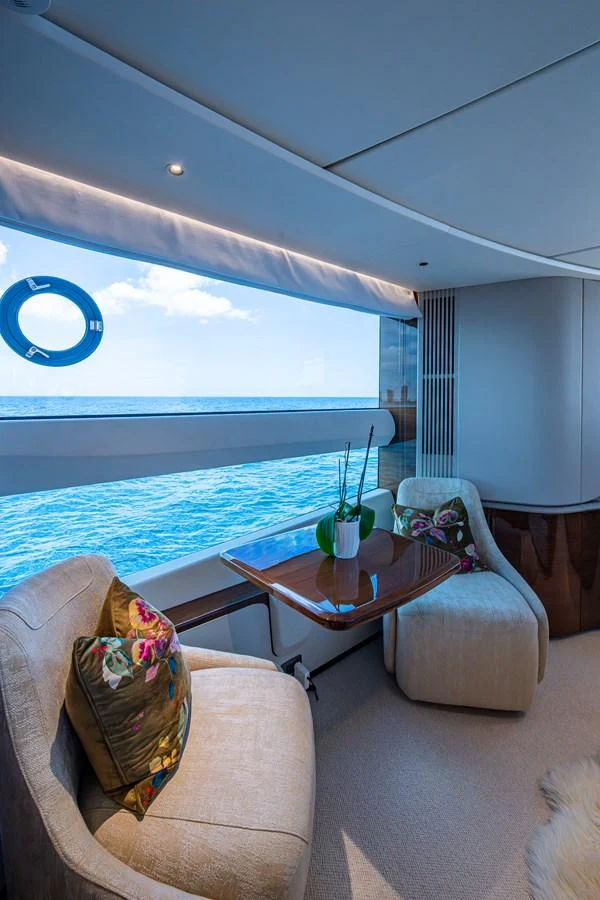 a room with a table and chairs aboard SPLASH Yacht for Sale