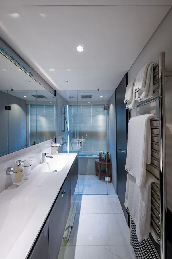 a bathroom with a large mirror aboard SPLASH Yacht for Sale
