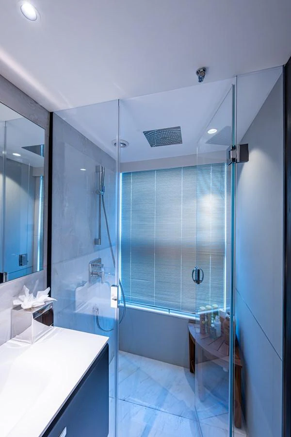 a bathroom with a shower unit and a sink aboard SPLASH Yacht for Sale