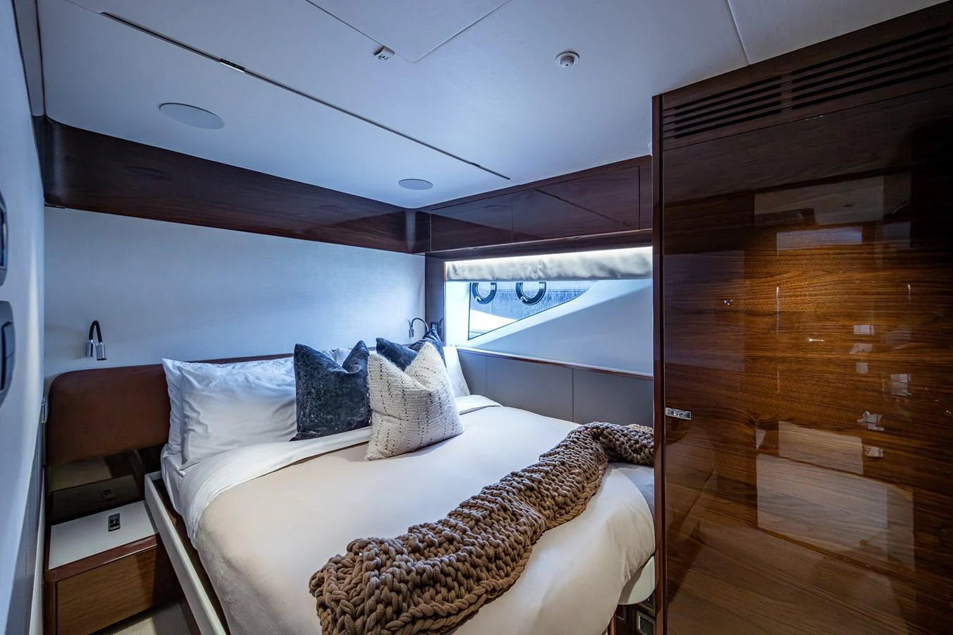 a room with a bed and a wood floor aboard SPLASH Yacht for Sale