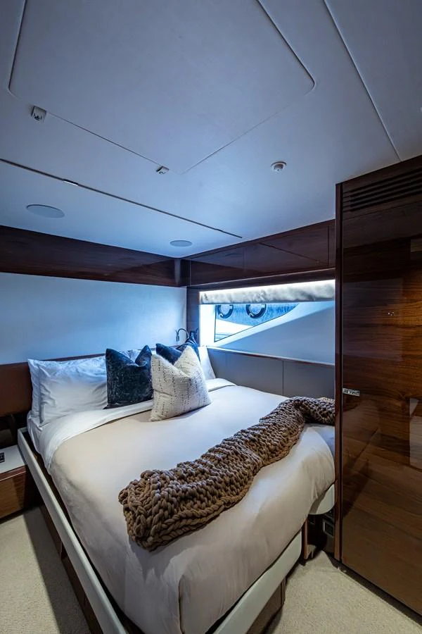 a bed with a white bed spread aboard SPLASH Yacht for Sale