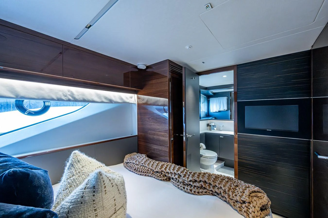 a bedroom with a bed and a television aboard SPLASH Yacht for Sale