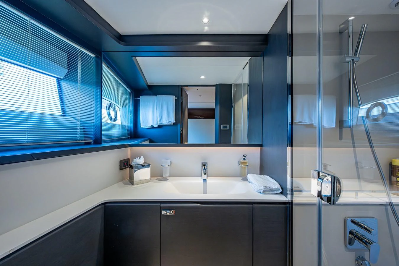 a bathroom with a large mirror aboard SPLASH Yacht for Sale