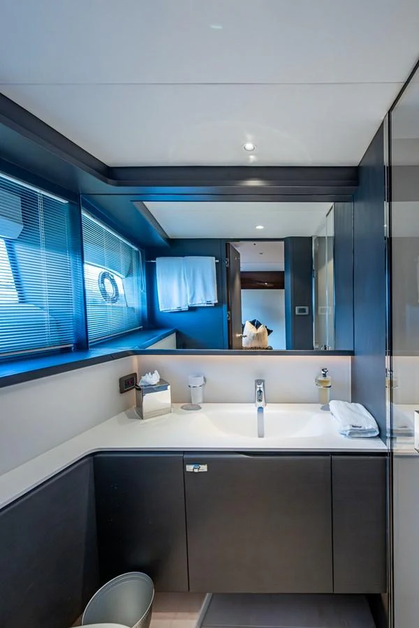 a bathroom with a large mirror aboard SPLASH Yacht for Sale