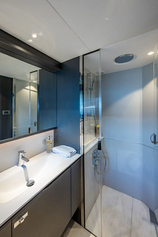 a bathroom with a shower unit and sink aboard SPLASH Yacht for Sale