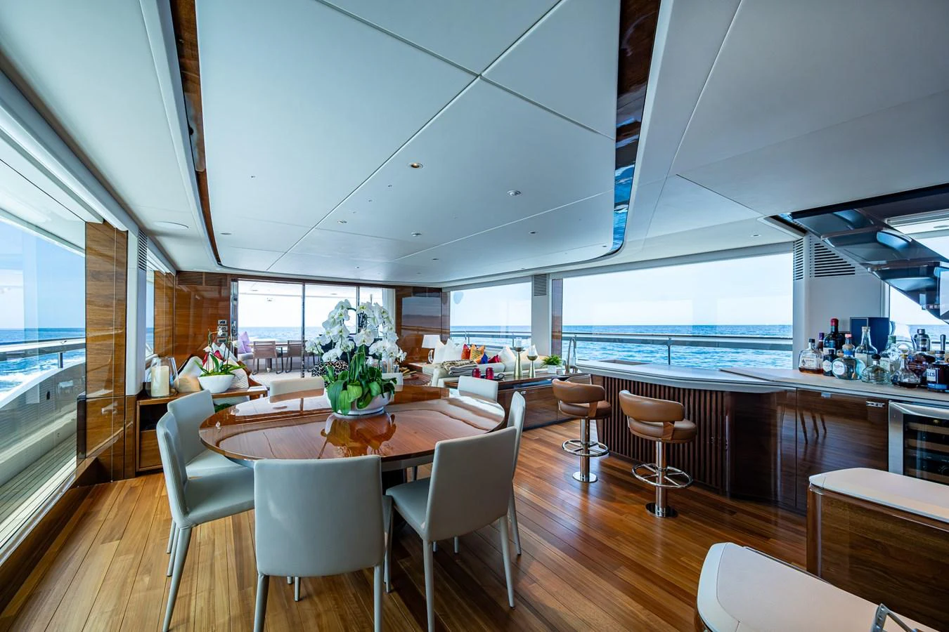 a large room with tables and chairs aboard SPLASH Yacht for Sale