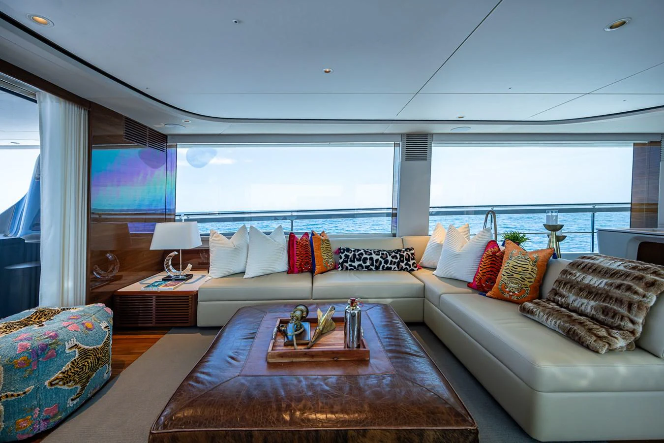 a living room with a large balcony aboard SPLASH Yacht for Sale