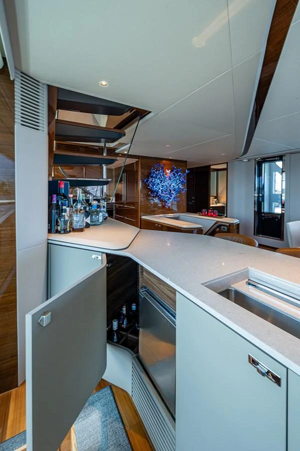 a kitchen with a sink and shelves aboard SPLASH Yacht for Sale