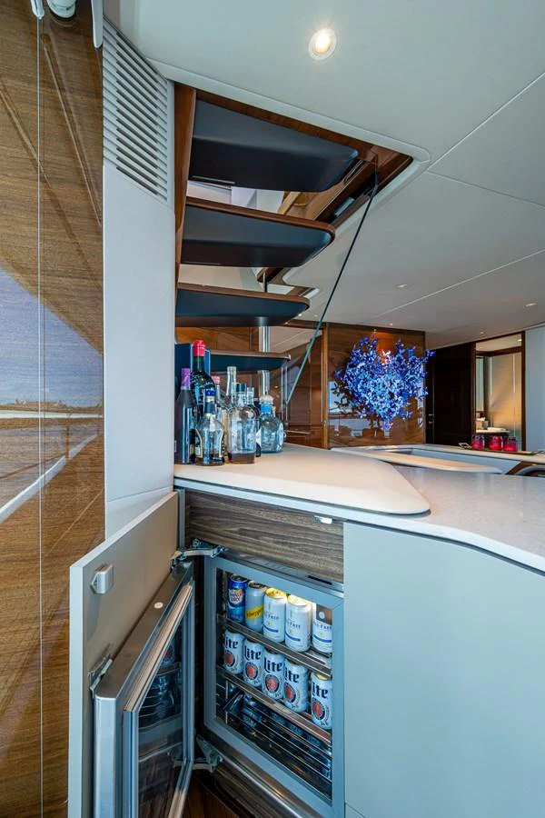 a kitchen with a fridge and shelves aboard SPLASH Yacht for Sale