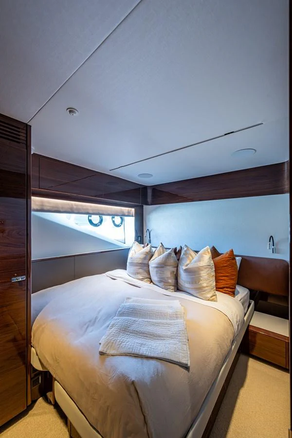 a room with a bed and a desk aboard SPLASH Yacht for Sale
