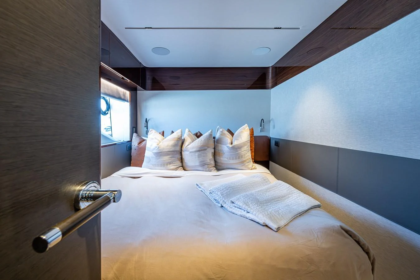 a bed with a wooden headboard aboard SPLASH Yacht for Sale
