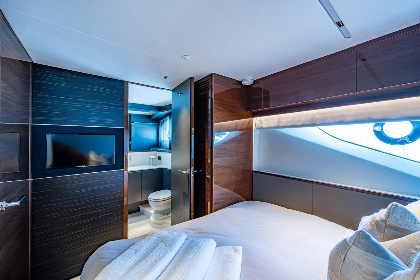 a room with a bed and a television aboard SPLASH Yacht for Sale