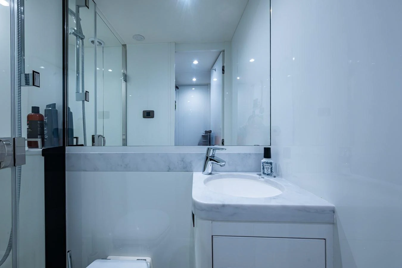 a bathroom with a large mirror aboard SPLASH Yacht for Sale