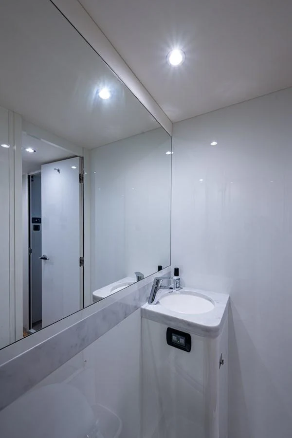 a bathroom with a large mirror aboard SPLASH Yacht for Sale