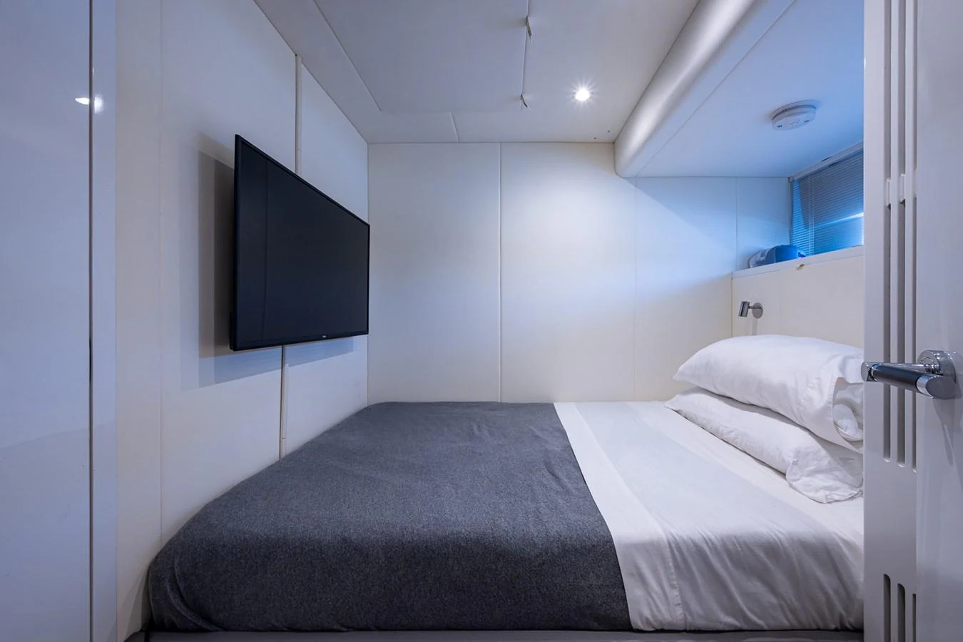 a room with a bed and a television aboard SPLASH Yacht for Sale